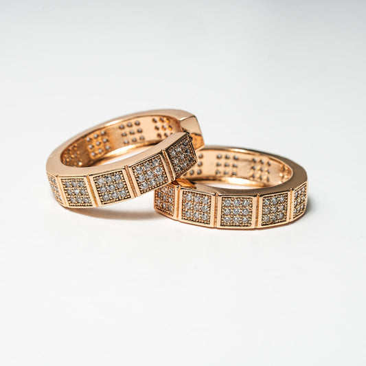 Two rose gold rings with diamond accents on a light gray background Harma Horizon Edge Zirconia Hoop Earrings