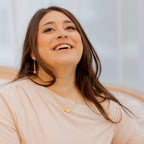 Woman wearing a beige top with a blurred background