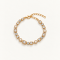 A gold-plated tennis bracelet featuring clear baguette and round-cut crystals, accented with small white pearls, displayed on a clean off-white background. Autumn Constellation Zirconia Bracelet | Harma Jewelry 18k gold plated