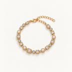 A gold-plated tennis bracelet featuring clear baguette and round-cut crystals, accented with small white pearls, displayed on a clean off-white background. Autumn Constellation Zirconia Bracelet | Harma Jewelry 18k gold plated