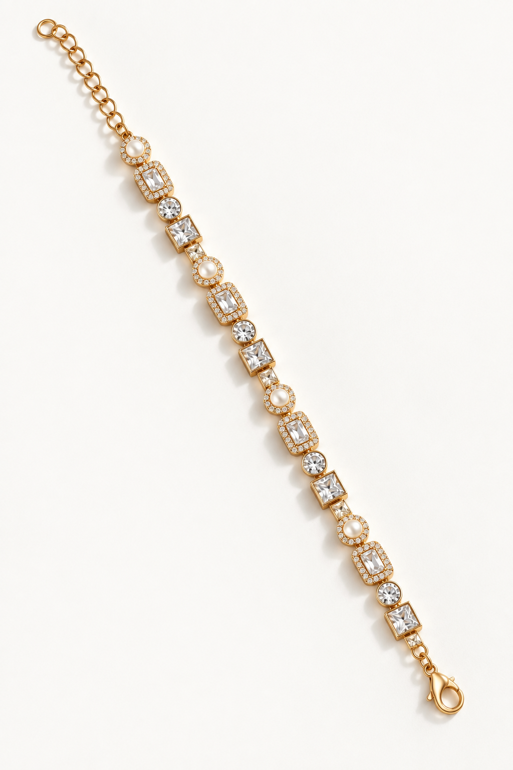 A gold tennis bracelet featuring alternating round pearl and rectangular clear gemstone links, displayed diagonally on a clean white background. Autumn Constellation Zirconia Bracelet | Harma Jewelry 18k gold plated