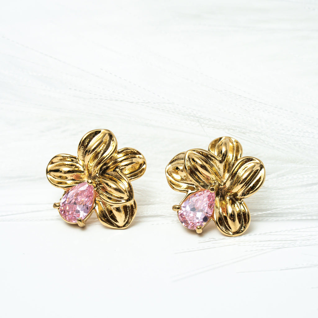 Gold flower-shaped earrings with pink centers on a white background. Harma gold plated Bloom Again Gold Earrings