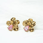 Gold flower-shaped earrings with pink centers on a white background. Harma gold plated Bloom Again Gold Earrings