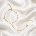 Gold bracelet with small pearls on a satin background