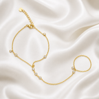 Gold bracelet with small pearls on a satin background