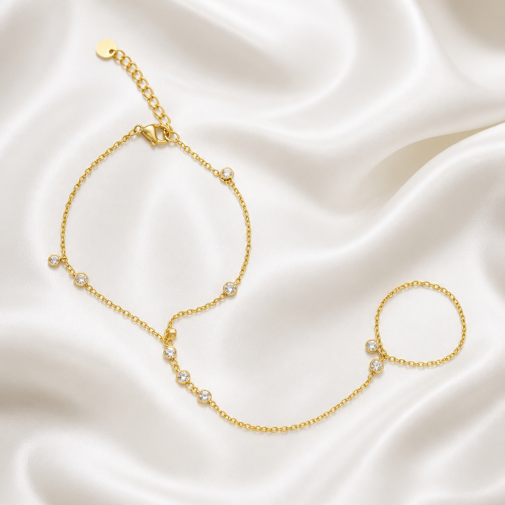 Gold bracelet with small pearls on a satin background