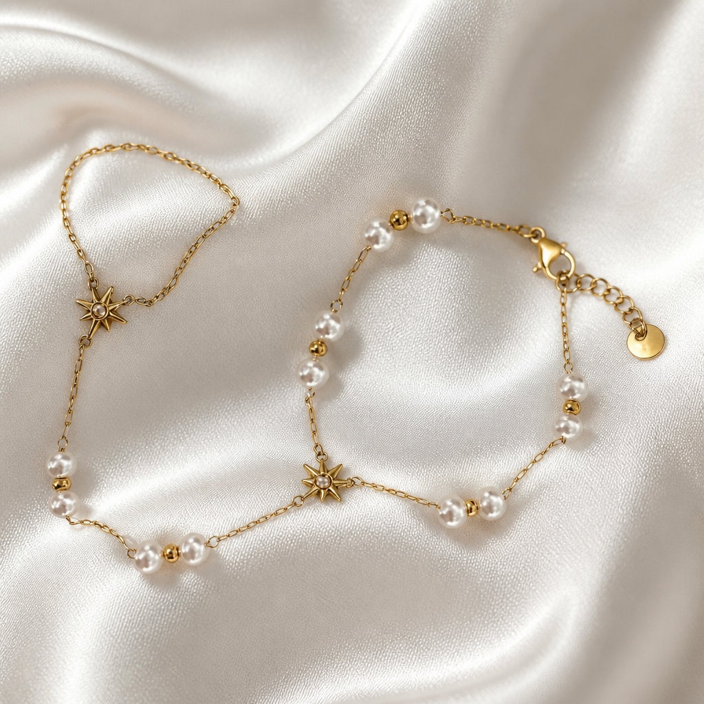 Gold necklace and bracelet set on a satin surface