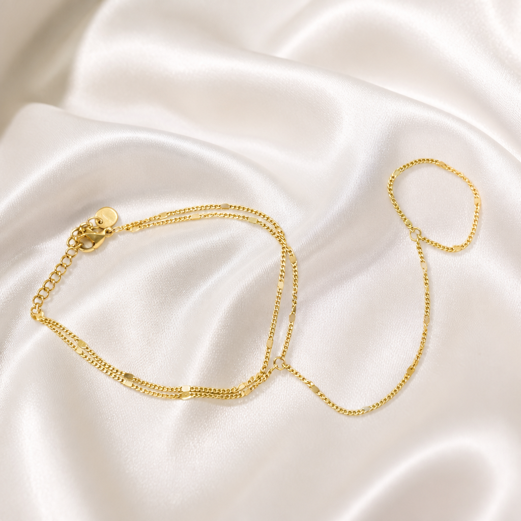 Gold bracelet on a soft white fabric background