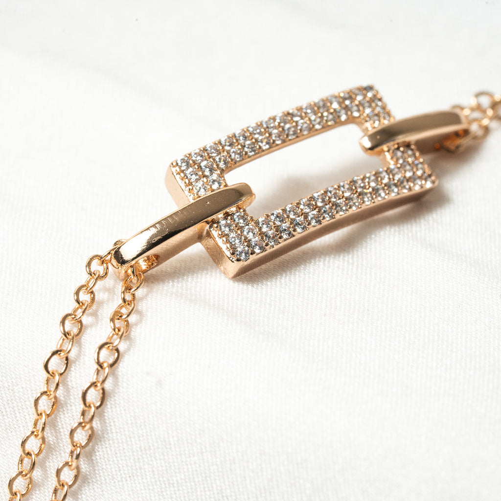 Rose gold bracelet with diamond accents on a white background. Harma 18k Gold plated Lustre Bond Link Bracelet