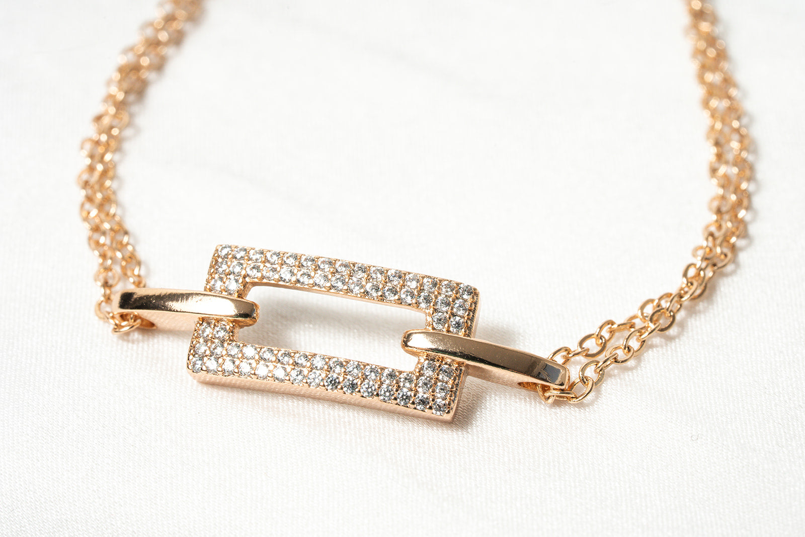 Rose gold necklace with a rectangular pendant on a white background. Harma 18k Gold plated Lustre Bond Link Bracelet