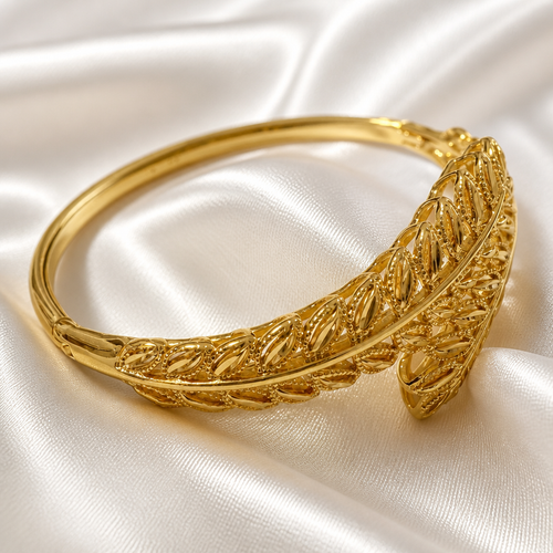 Gold bracelet on a white satin background