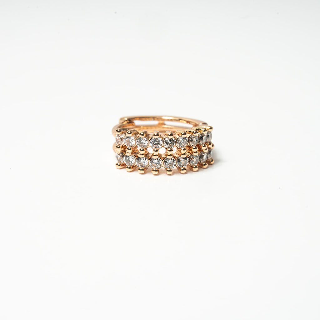 Gold ring with embedded diamonds on a white background Harma Aurora Glow Hoop Earrings