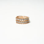 Gold ring with embedded diamonds on a white background Harma Aurora Glow Hoop Earrings