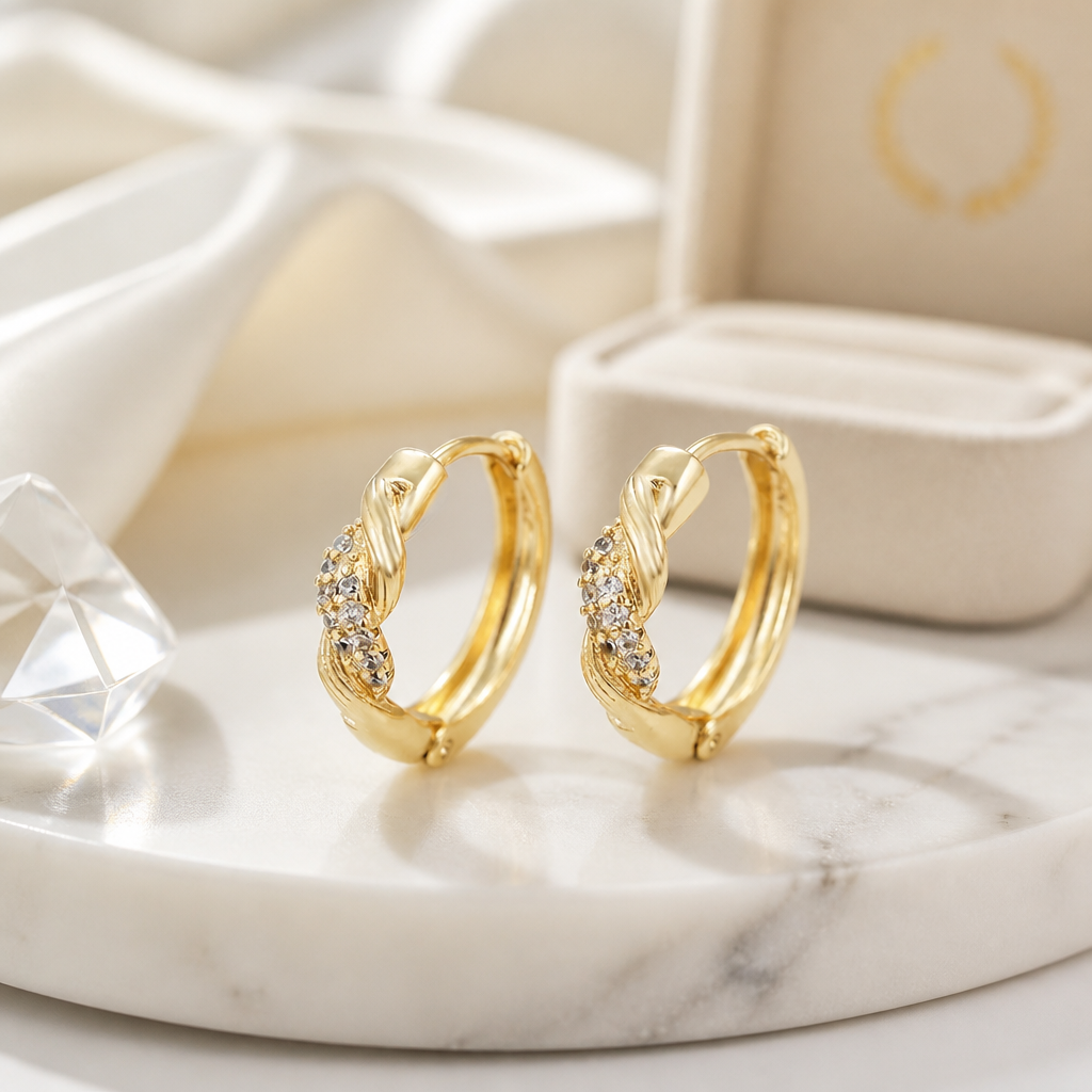 Gold hoop earrings with diamond accents on a marble surface