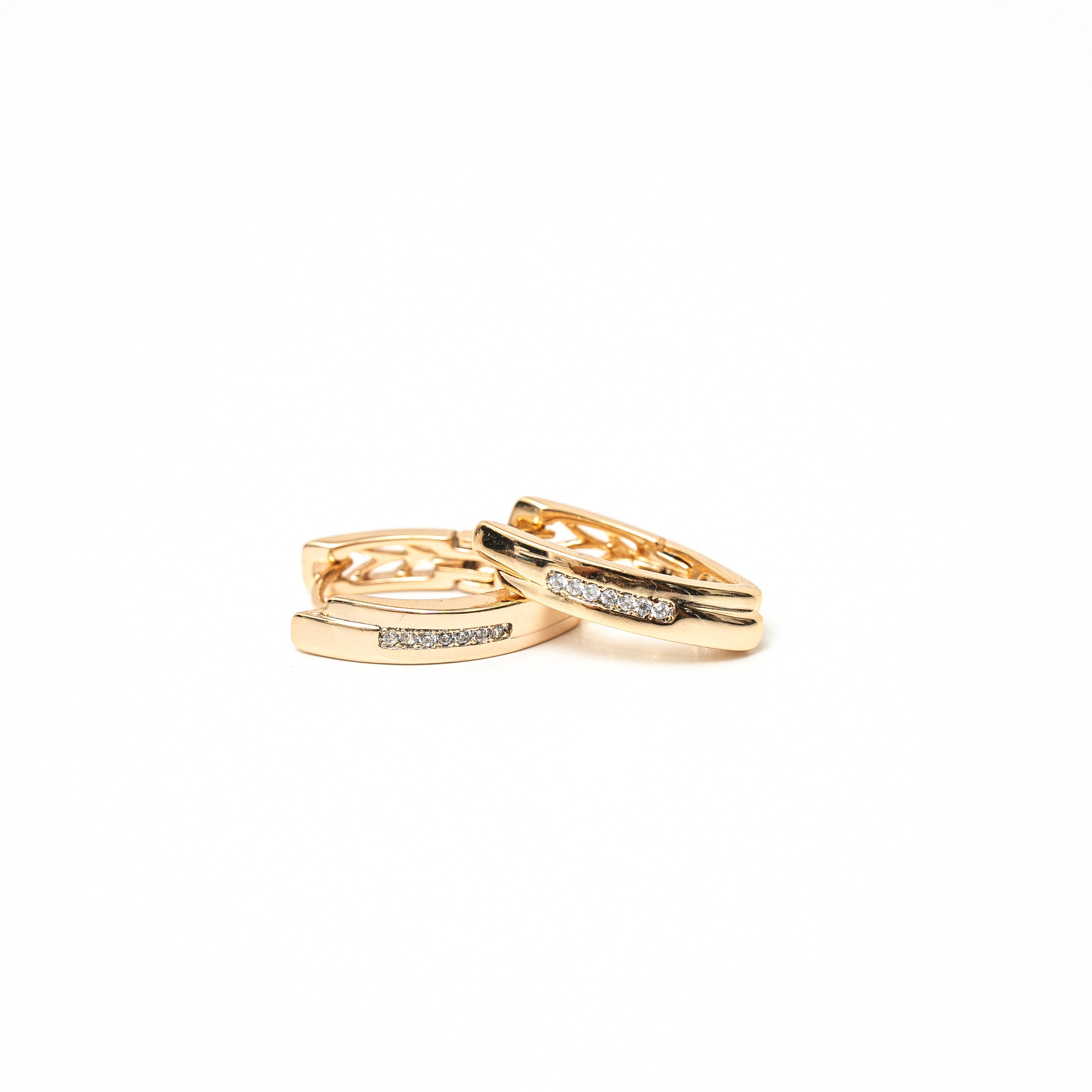Two gold rings with diamond accents on a white background. Harma Gold Plated Resilient Spark Gold Earrings