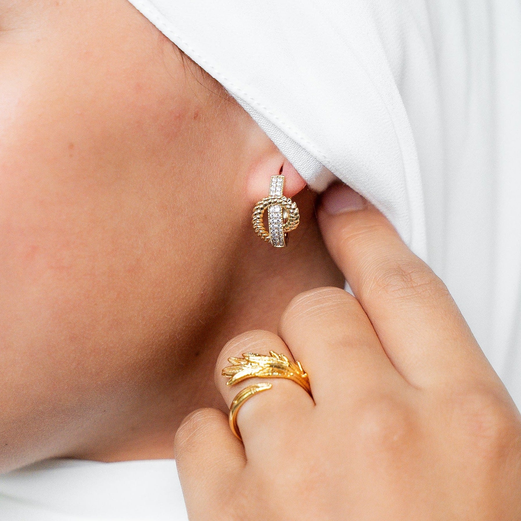 Woman wearing a white hijab and gold jewelry on a plain background. Harma Gold plated I Am at Peace Vine Hoop Earrings