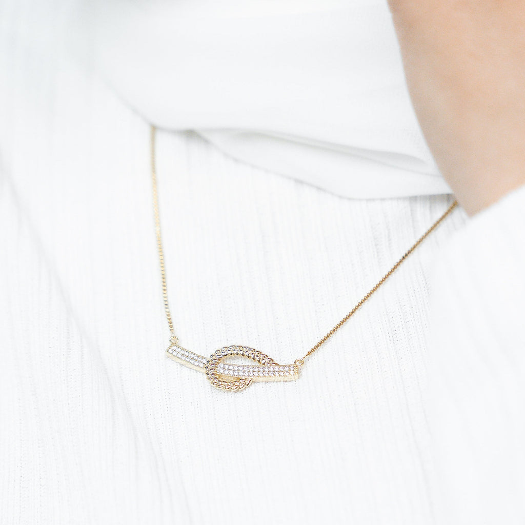 Rose gold necklace with a unique pendant on a white background. Harma Gold plated I Am at Peace Vine Hoop Necklace