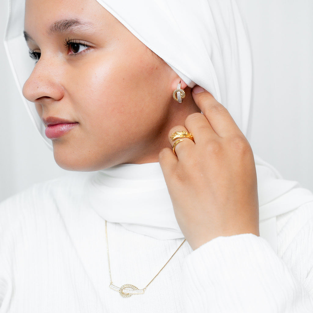 Woman wearing a white hijab and gold jewelry on a plain background Harma Gold plated I Am at Peace Vine Hoop Earrings