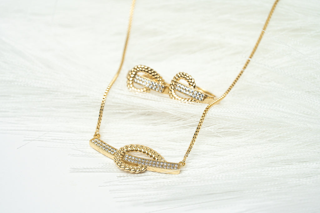 Gold necklace with heart-shaped pendants on a white background. Harma Gold plated I Am at Peace Vine Hoop Necklace 