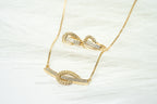 Gold necklace with heart-shaped pendants on a white background. Harma Gold plated I Am at Peace Vine Hoop Necklace 