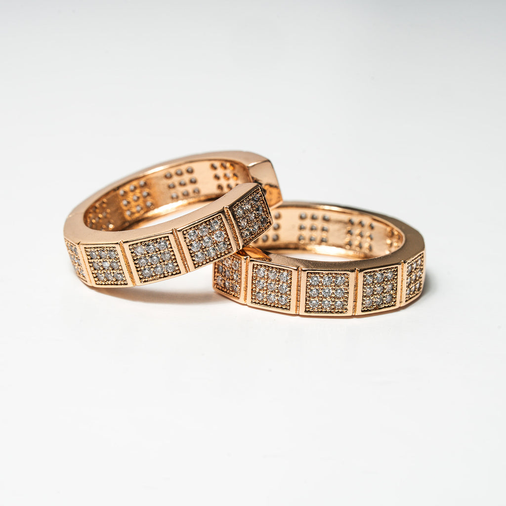 Two rose gold rings with diamond accents on a light gray background Harma Horizon Edge Zirconia Hoop Earrings