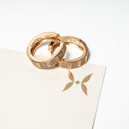 Two rose gold rings on a white card with a logo Harma Horizon Edge Zirconia Hoop Earrings