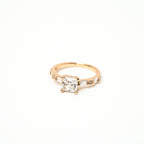 White princess cut stone with cubic zirconia around the ring in baguette cut with white background. solitair ring 