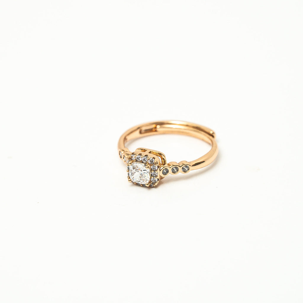 Gold ring with a diamond on a white background 