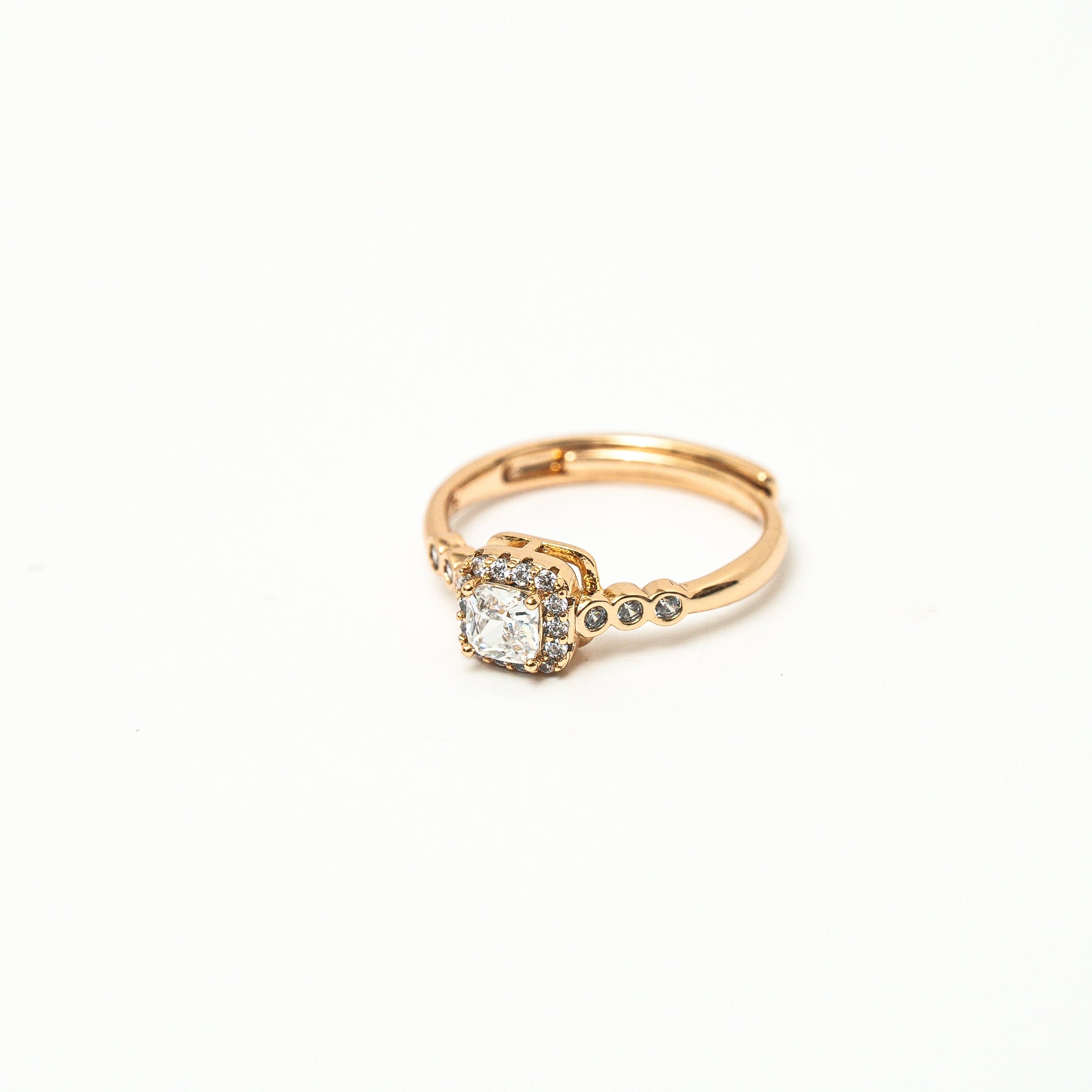 Gold ring with a diamond on a white background 