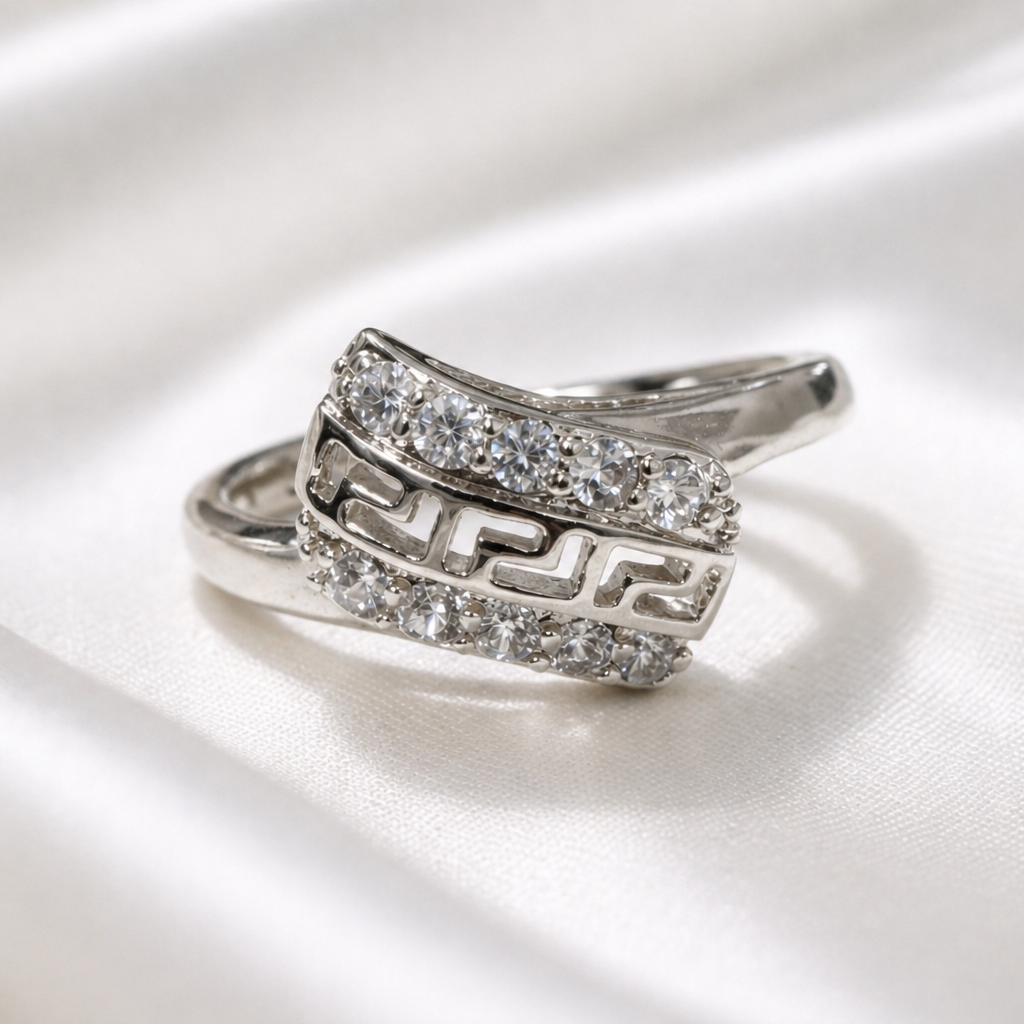 Silver ring with gemstones on a white satin background