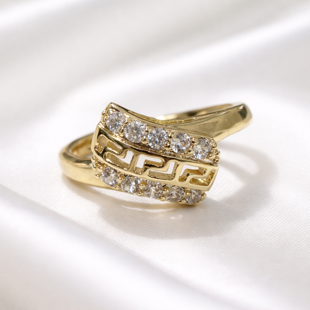 Gold ring with diamond accents on a white background