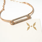 Rose gold bracelet with diamond accents on a white background. Harma Jewelry Cubic Zirconia Incrusted Sumptuous Paper Clip Bangle Chain