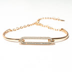 Gold bracelet with diamond accents on a white background. Harma Jewelry Cubic Zirconia Incrusted Sumptuous Paper Clip Bangle Chain