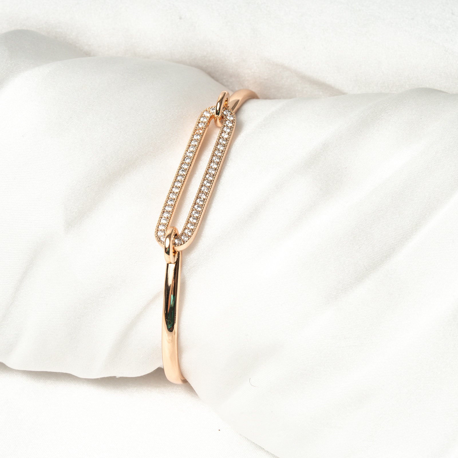 Rose gold bracelet with clear stones on a white pillow. Harma Jewelry Cubic Zirconia Incrusted Sumptuous Paper Clip Bangle Chain