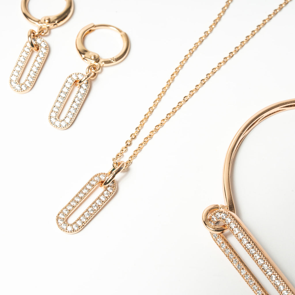 Rose gold jewelry set including necklace, hoop earrings, and bracelet on a white background. Harma Jewelry Cubic Zirconia Incrusted Sumptuous Paper Clip Bangle Chain Necklace Earrings Set