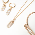 Rose gold jewelry set including necklace, hoop earrings, and bracelet on a white background. Harma Jewelry Cubic Zirconia Incrusted Sumptuous Paper Clip Bangle Chain Necklace Earrings Set