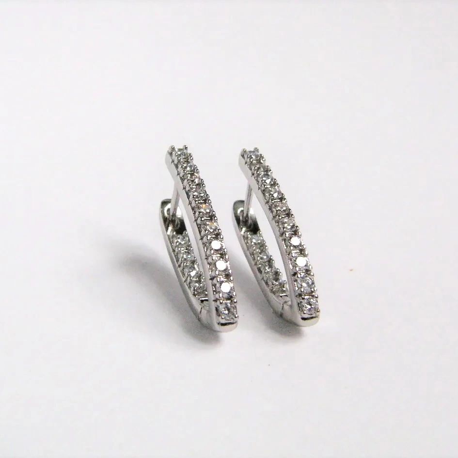 Pair of diamond hoop earrings on a light gray background Harma Jewelry Cubic Zirconia Inside out Huggie Hoop Earrings 