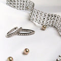 Silver bracelet, ring, and earrings on a white background Harma Jewelry Cubic Zirconia Inside out Huggie Hoop Earrings 