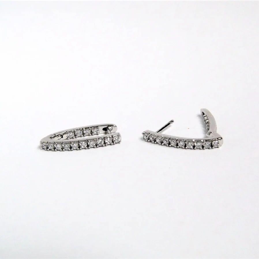 Pair of silver hoop earrings on a white background Harma Jewelry Cubic Zirconia Inside out Huggie Hoop Earrings