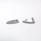 Pair of silver hoop earrings on a white background Harma Jewelry Cubic Zirconia Inside out Huggie Hoop Earrings