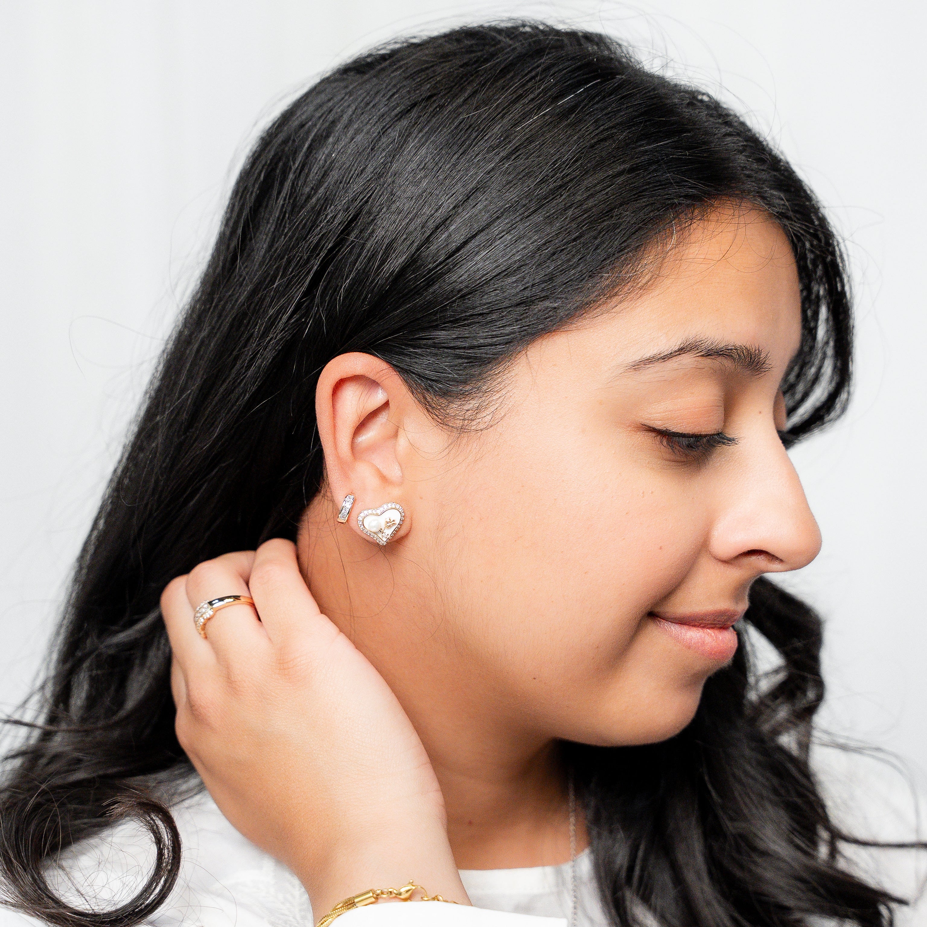 Woman wearing earrings with a plain background
