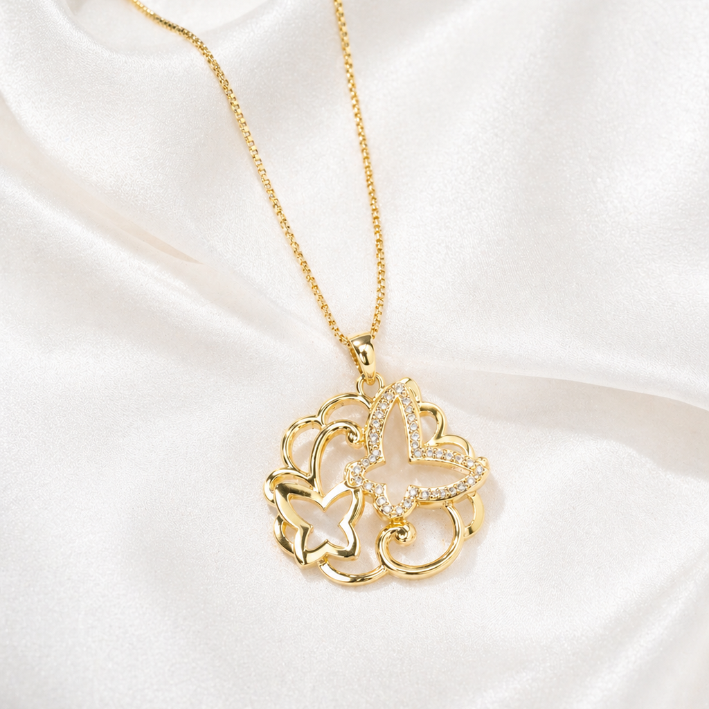 Gold necklace with a butterfly pendant on a white satin background