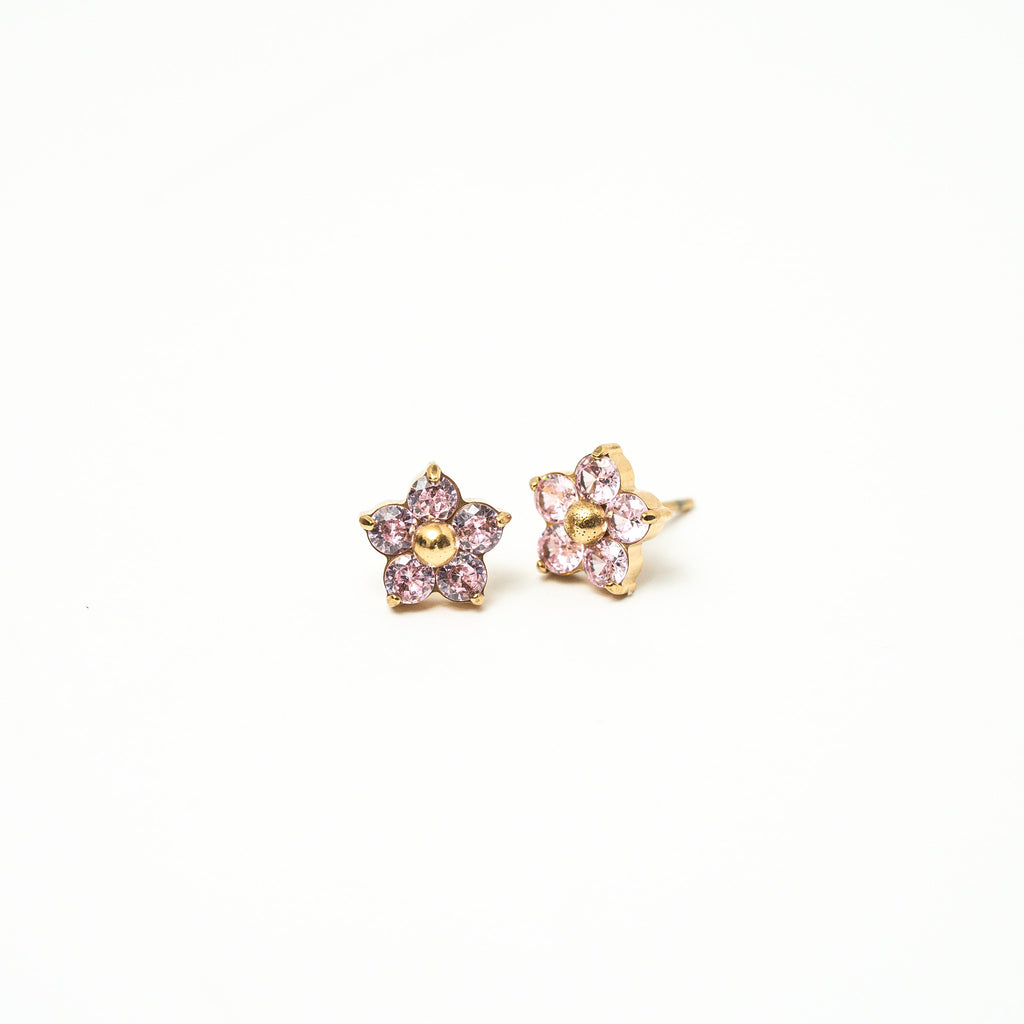 Pair of star-shaped earrings with pink gemstones on a white background. Harma Jewelry Gold Plated Little Bloom PINK Zirconia Earrings