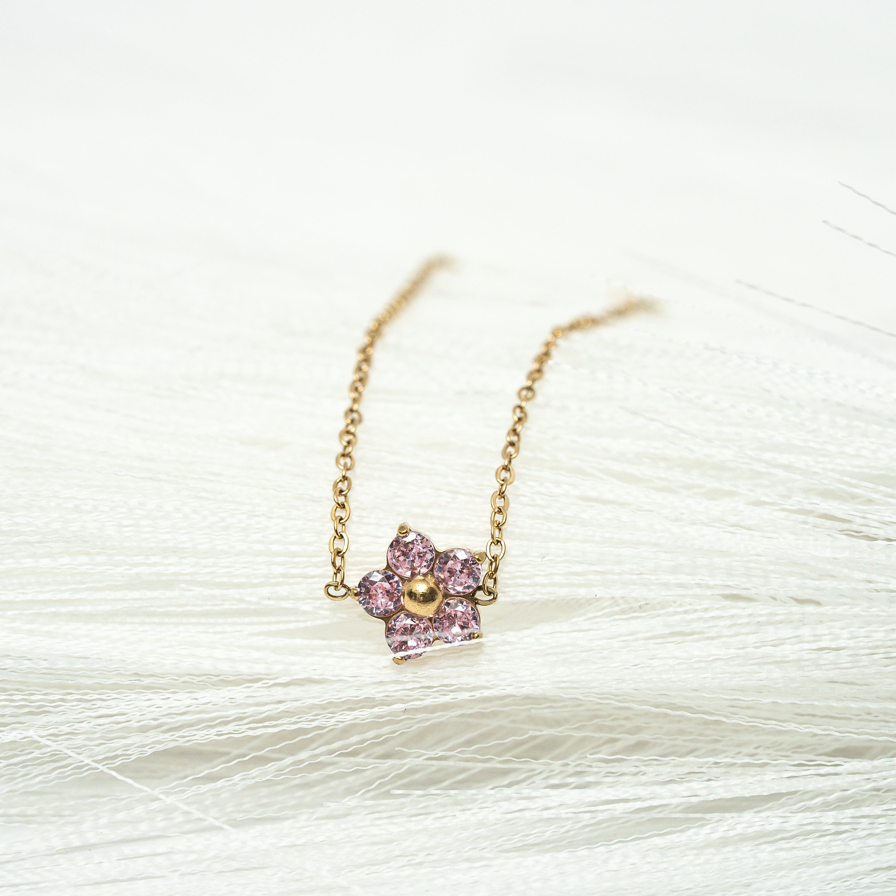 Necklace with a pink pendant on a white background. Harma Jewelry Gold plated Little Bloom PINK Zirconia Bracelet