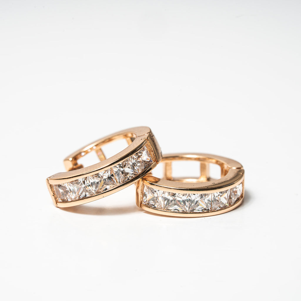 Rose gold hoop earrings with clear gemstones on a light background Harma Jewelry Medium Hoops Cubic Zirconia Lined Backing