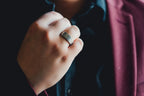 Hand wearing a gold ring with a blurred background  Harma Jewelry Men Tungsten Carbide Band Ring Silver Hammered 