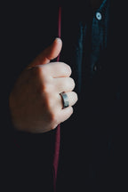 Hand wearing a ring holding a red object against a dark background  Harma Jewelry Men Tungsten Carbide Band Ring Silver Hammered 