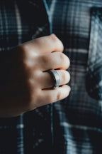 Hand wearing a ring with a blurred plaid shirt background Harma Jewelry Men Tungsten Carbide Band Ring Silver Simple 