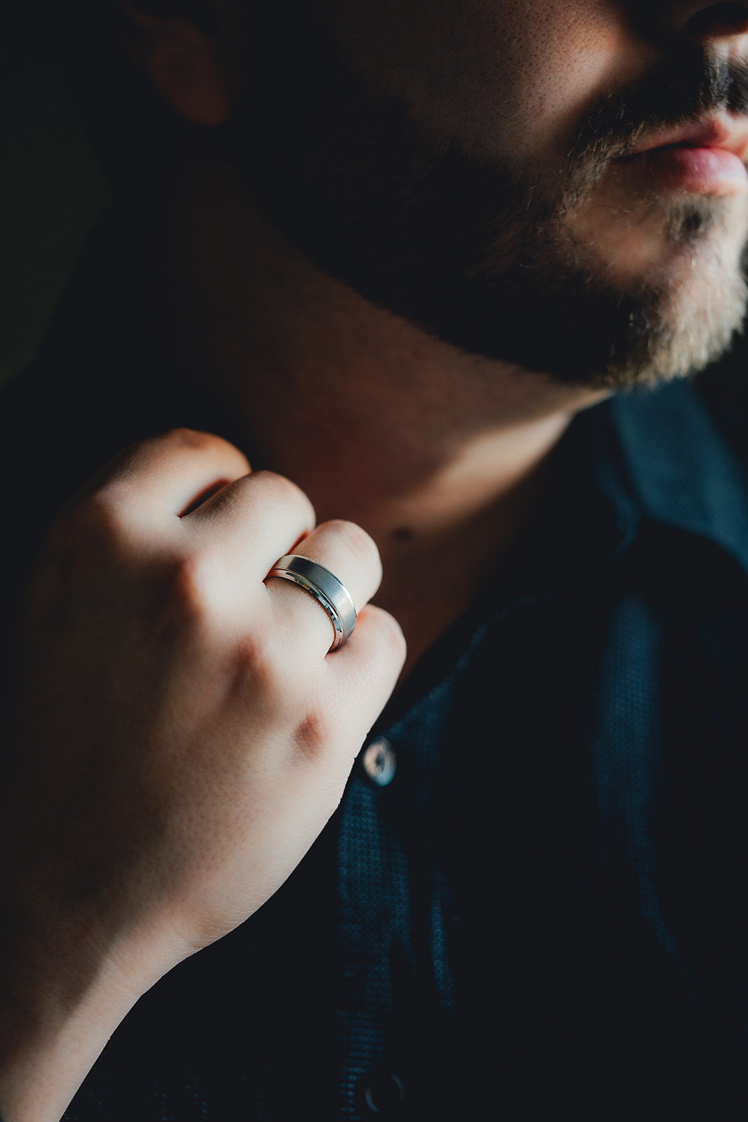 Close-up of a person wearing a silver ring with a blurred background Harma Jewelry Men Tungsten Carbide Band Ring Silver Simple 