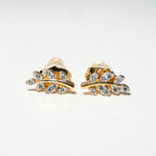 Gold leaf-shaped earrings with clear gemstones on a white background. Harma Jewelry Olive Branch Of Hope Stud Earrings Full Cubic Zirconia Gold Plated
